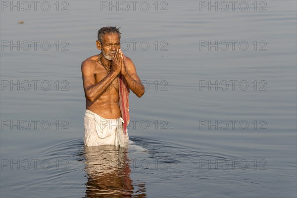 Pilgrim taking a bath praying in the holy Yamuna river