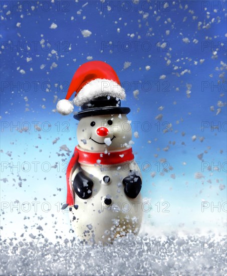 Snowman figure with a Santa Claus hat in the snow