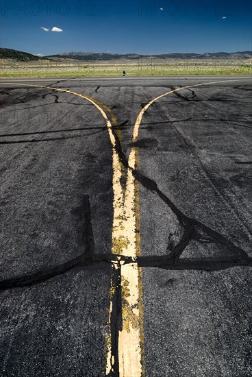 Yellow worn tarmac markings at an airport