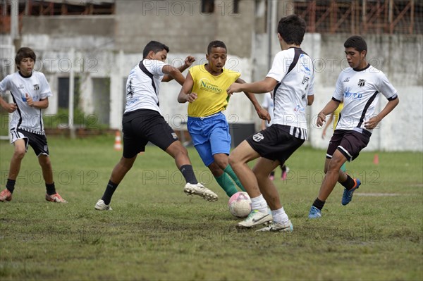 Street children playing a friendly soccer match against a youth team