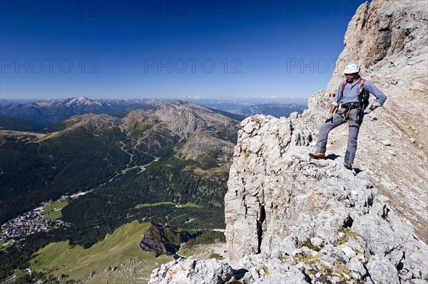 Mountain climber ascending the Via Ferrata Bolver-Lugli climbing route on the Cima Vezzana Mountain in the Pala Group or Pala di San Martino