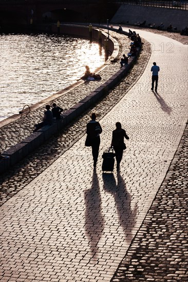 Passers-by in the evening light