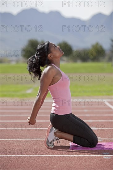 Sporty young woman on running track