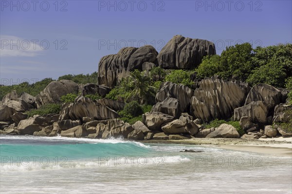 Sandy beach with the rock formations typical for the Seychelles