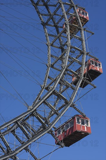 Three cabins of the Wiener Riesenrad ferris wheel against a blue sky at the Prater