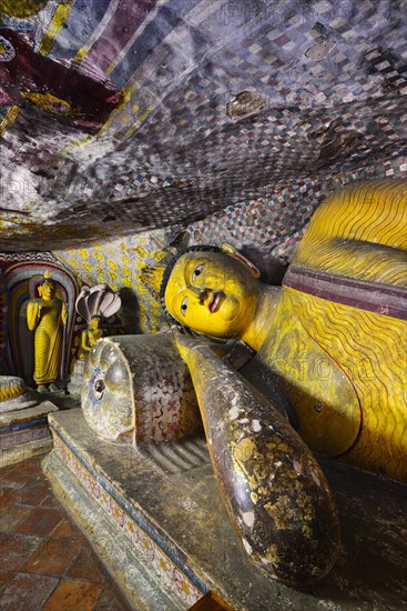 Buddha statues and murals in one of the cave temples of the Golden Temple