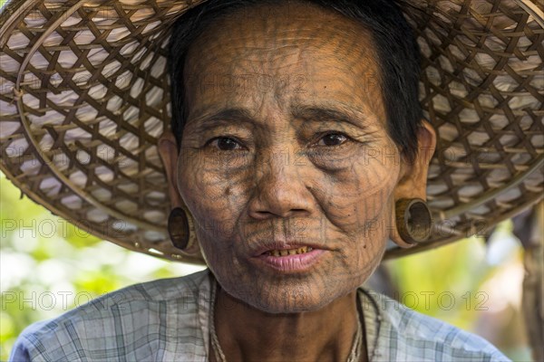 Woman with a traditional facial tattoo and ear jewelry