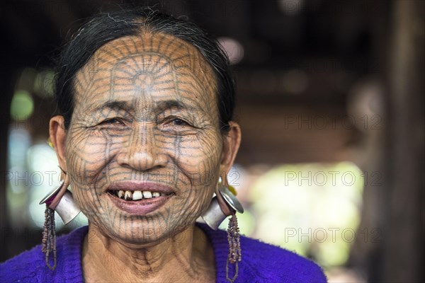 Woman with a traditional facial tattoo and ear jewelry