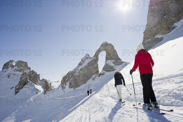 Skiers and snow-covered mountains