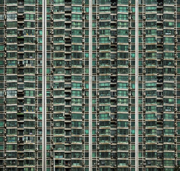 Facade of a high-rise building with balconies and air conditioning units