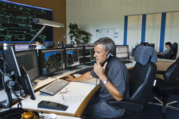 Shift supervisor Hans-Peter Polzer sitting at his work station in the Transmission Control Center