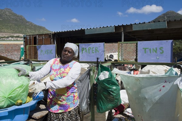 Woman working at a collecting point for recycling