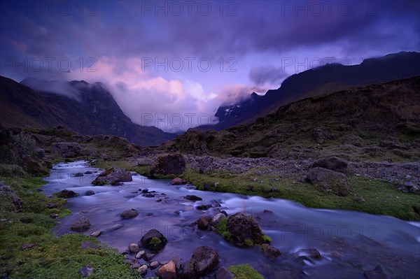 Mountain stream with the peaks of El Altar or Kapak Urku