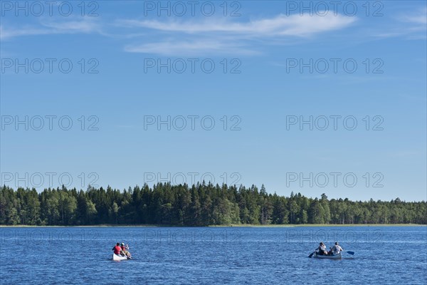 Two canoes with canoeists on Lake Asnen