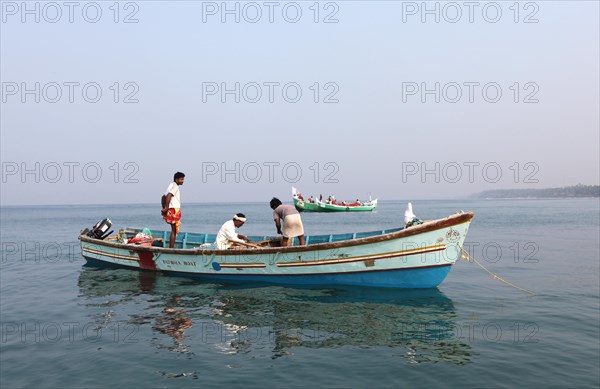 Local mussel fishermen in their boat off the coast