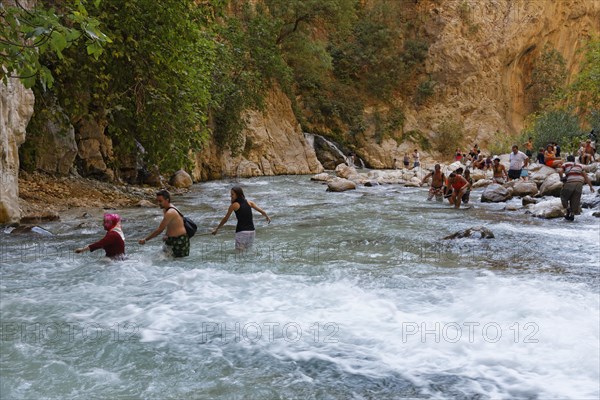 Tourists crossing the river