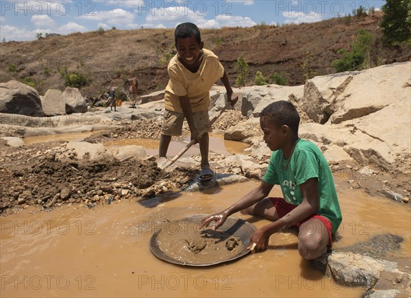 Two children digging for gold