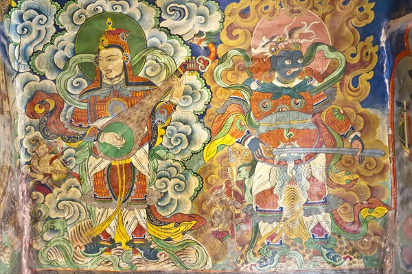Musicians and demon mural at the entrance of the Tashi Choling Gompa