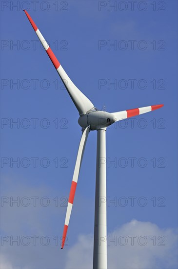 Wind turbine against blue sky