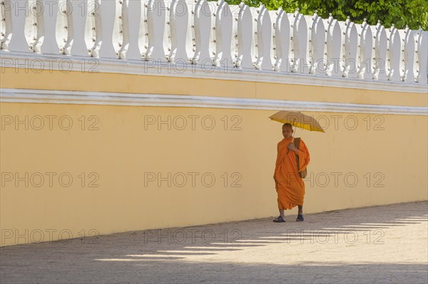 Buddhist monk walking along the walls of the Royal Palace