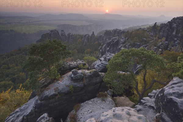 View of the Schrammsteine in the Elbe Sandstone Mountains at sunset in autumn