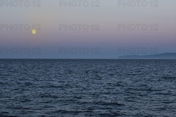 Moon setting over the Bering Strait