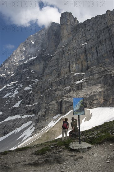 Info panel and hikers on the Eiger Trail