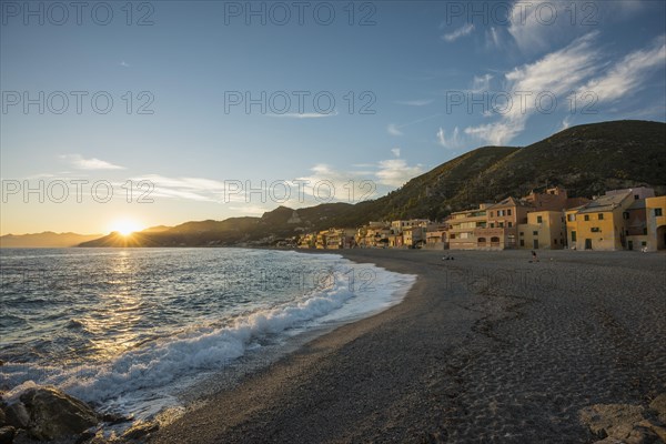 Typical houses on the beach at sunset