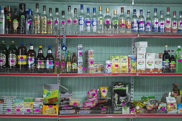 Alcoholic beverages and sweets on sale at a village market