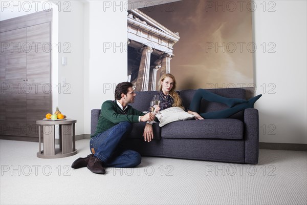 Man and woman on a couch in a hotel room