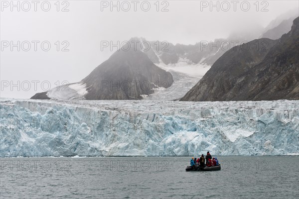 Tourists and guides in an inflatable boat