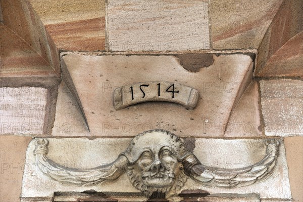 Grotesque with braids on a doorway from 1514