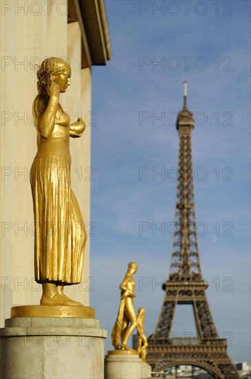 Golden statues at the Palais de Chaillot with the Eiffel Tower