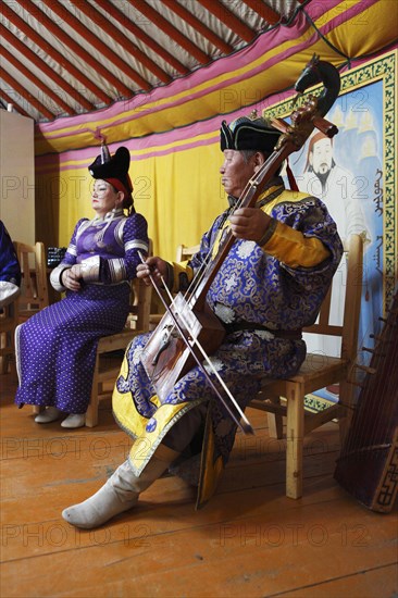Man in the traditional costume of the Khalkha Mongols playing the horse-head fiddle