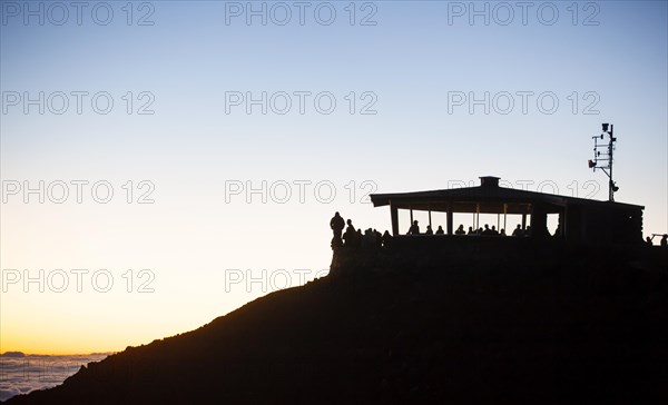 Tourists awaiting the sunrise on the summit of the Haleakala volcano