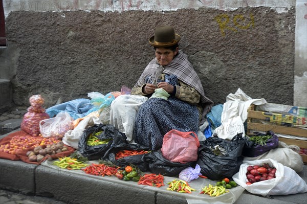 Old market woman in the traditional costume of the Quechua people