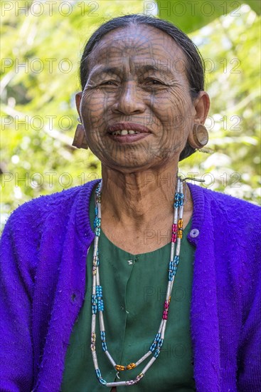 Woman with a traditional facial tattoo and ear jewelry