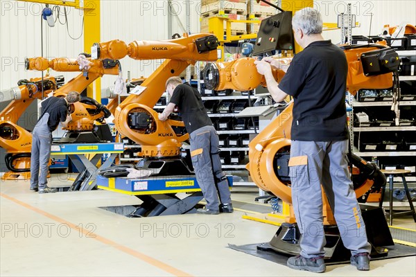 Employees of the robot manufacturer KUKA AG during the assembly of the electrical system of KUKA robots