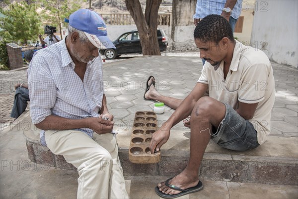 Men playing a board game