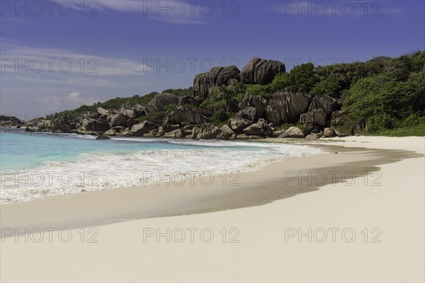 Sandy beach with the rock formations typical for the Seychelles