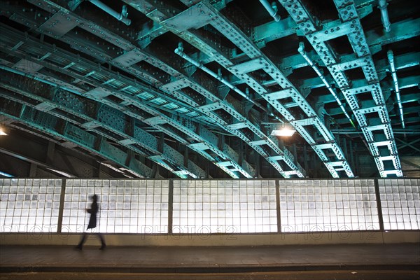 Pedestrian in an illuminated underpass