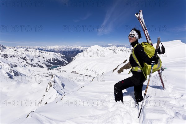 Winter sportswoman on a mountain peak