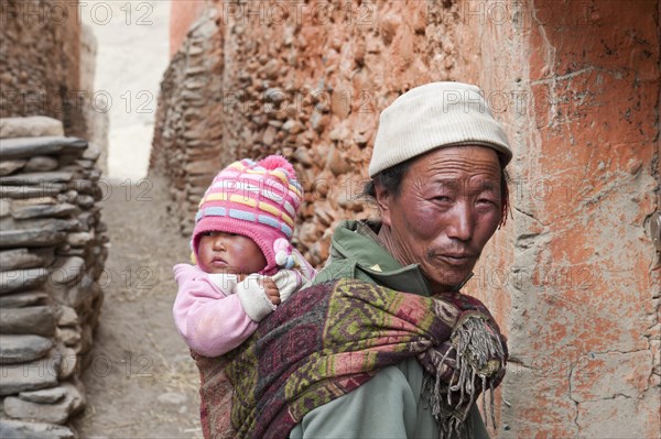 Man carrying a baby on his back