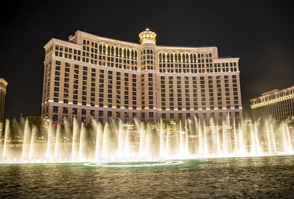 Illuminated fountain in front of the Bellagio Hotel at night