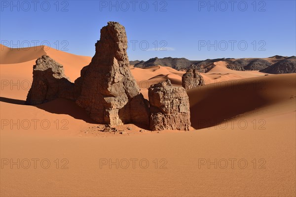 Rock towers in the sand dunes of Tin Merzouga