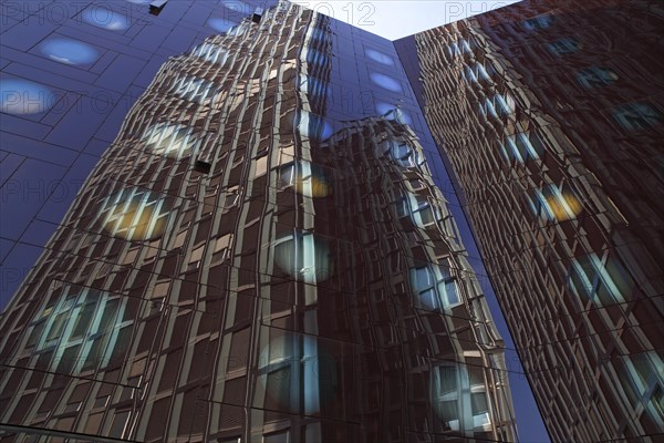 Tanzende Turme office building reflected in the facade of the Arcotel Onyx Hotel