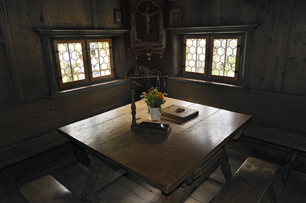 Herrgottswinkel prayer niche with a table and benches in Markus Wasmeier Farm and Winter Sports Museum