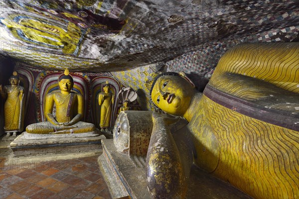 Buddha statues and murals in one of the cave temples of the Golden Temple