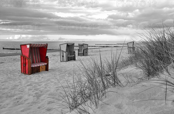 Roofed wicker beach chairs on the beach