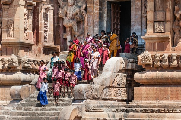 Children and devout Hindus descending a staircase